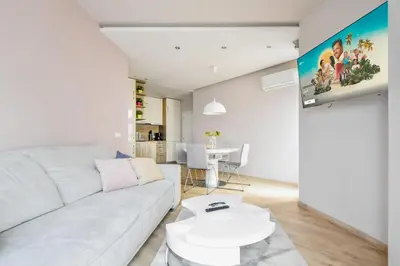a living room with a white couch and a table at Charming 2BD with Mountain View by Flat Mаnager in Sofia