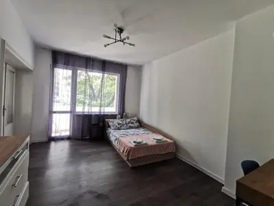 a bedroom with a bed and a window at Spacious&Cousy 3 bedroom apartment in Plovdiv