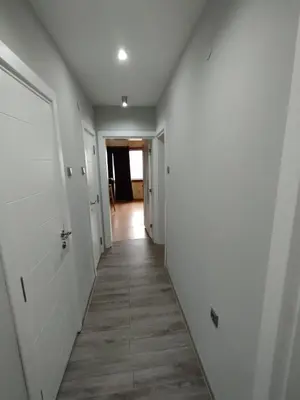 a hallway with white walls and a wooden floor at Nadi in Plovdiv