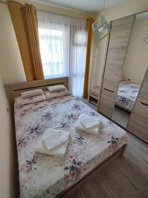 a bedroom with a large bed with two towels on it at Nadi in Plovdiv