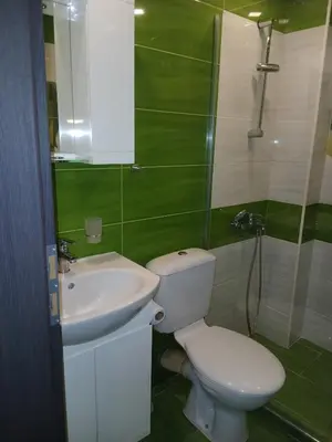 a bathroom with a white toilet and a sink at Zoraja in Sofia
