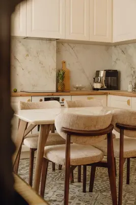 a kitchen with tables and chairs in a kitchen at Elegant Escape-High Ceilings, Balcony & Piano by Flat Mаnager in Sofia