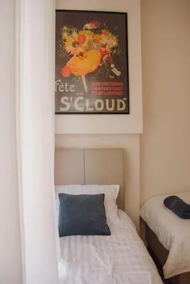 a room with a bed and a picture of a scholar at Elegant Escape-High Ceilings, Balcony & Piano by Flat Mаnager in Sofia
