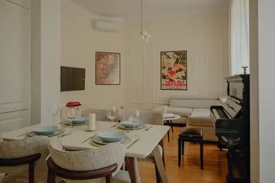 a living room with a table and a piano at Elegant Escape-High Ceilings, Balcony & Piano by Flat Mаnager in Sofia