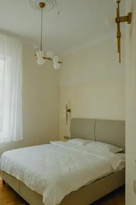 a bedroom with a white bed and a ceiling fan at Elegant Escape-High Ceilings, Balcony & Piano by Flat Mаnager in Sofia