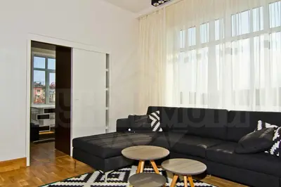 a living room with a black couch and a table at Casa Desideria 2BAD 2BATH, PARKING , Vitosha Blvd in Sofia