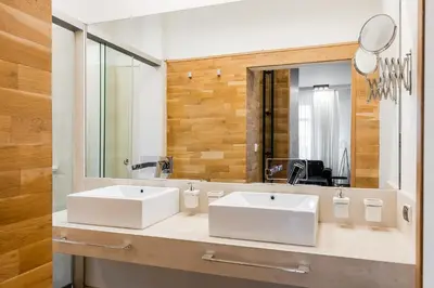 a bathroom with two white sinks and a mirror at Casa Desideria 2BAD 2BATH, PARKING , Vitosha Blvd in Sofia