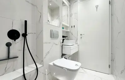 a white bathroom with a toilet and a shower at Bright Central Sofia Flat with Coffee-Lovers Touch by Flat Mаnager in Sofia
