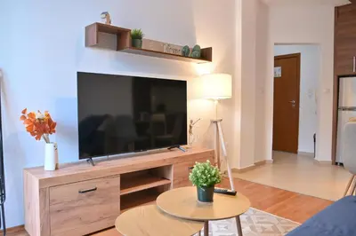 a living room with a large flat screen tv at Cozy Flat with Pool & Mountain Views, Near Gondola by Flat Mаnаger in Bansko