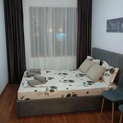 a bedroom with a large bed with flowers on it at Bella apartment Bansko in Bansko