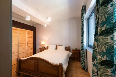a bedroom with a bed and a window at Къща за гости 