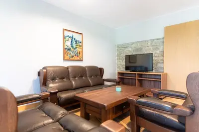 a living room with a couch and a table at Къща за гости 