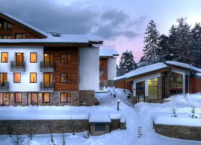 a building with snow on the ground in front of it at Private Studio Pine Whisper 4 pax in Euphoria Club in Borovets