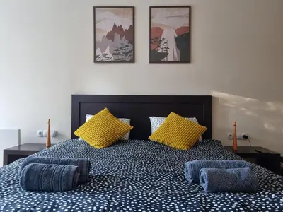 a bedroom with a bed with yellow and blue pillows at Private Studio Pine Whisper 4 pax in Euphoria Club in Borovets