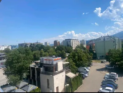 a view of a city with cars parked in a parking lot at Student City Vitosha View Apartment in Sofia