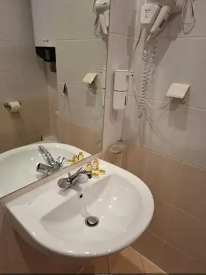 a bathroom with a white sink and a phone at Cozy studio 125 in Villa Park in Borovets