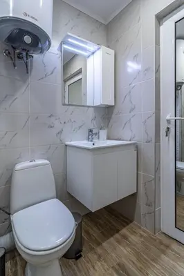 a bathroom with a toilet and a sink and a mirror at 20th Residence One Bedroom Apartment - Private Parking Included in Sofia