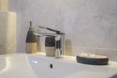 a bathroom sink with a faucet and a toothbrush at 2-Bedroom Apartment in the City Center in Plovdiv