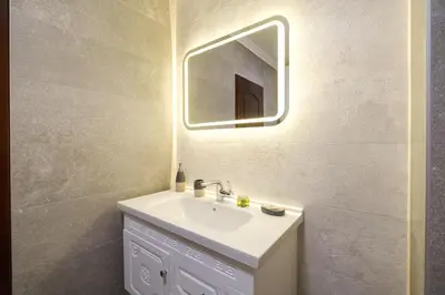 a bathroom with a sink and a mirror at 2-Bedroom Apartment in the City Center in Plovdiv