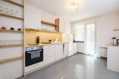 a kitchen with white cabinets and a stove top oven at 2-Bedroom Apartment in the City Center in Plovdiv