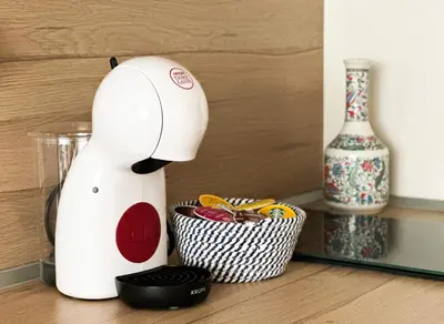 a white blender sitting on a counter next to a cupcake at Sunny Sofia Studio with Balcony by Flat Mаnager in Sofia