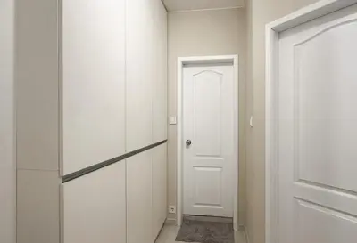a hallway with white cabinets and a white door at Sunny Sofia Studio with Balcony by Flat Mаnager in Sofia