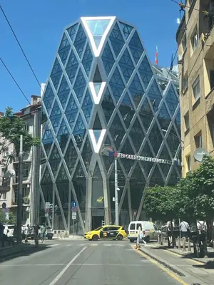 a large glass building on a city street at Charming Loft Sofia Center in Sofia