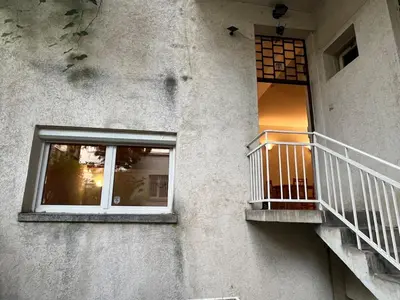 a building with a balcony and a window at Charming Loft Sofia Center in Sofia
