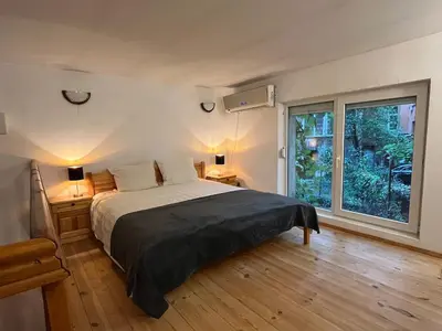 a bedroom with a bed and a large window at Charming Loft Sofia Center in Sofia