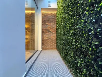 a hallway with a large green wall at London - English Basement Studio in Sofia