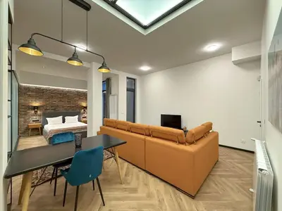 a living room with a couch and a bedroom at London - English Basement Studio in Sofia