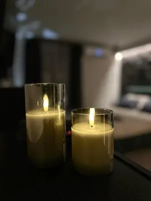 two candles sitting on top of a table at Къща за гости Рилски чардак in Sapareva Banya