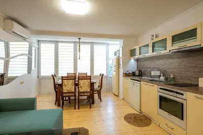 a kitchen and dining room with a table and chairs at Bendida Classic in Velingrad
