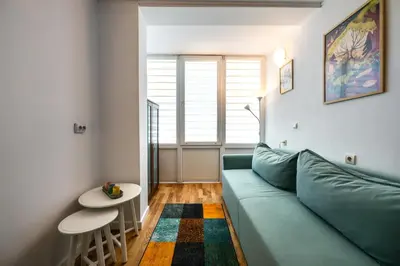 a living room with a blue couch and a table at Bendida Classic in Velingrad