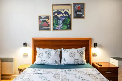 a bedroom with a bed with blue and white pillows at Bendida Classic in Velingrad