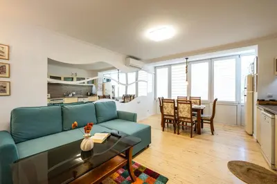 a living room with a blue couch and a table at Bendida Classic in Velingrad