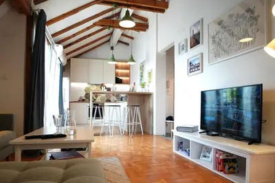 a living room with a couch and a flat screen tv at Modern Loft with Balcony in the heart of Sofia in Sofia