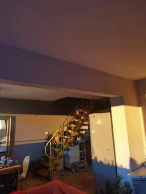 a living room with a staircase in a room at Artsy Penthouse & mountain view in Sofia