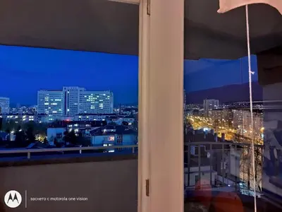 a view of a city at night from a window at Artsy Penthouse & mountain view in Sofia