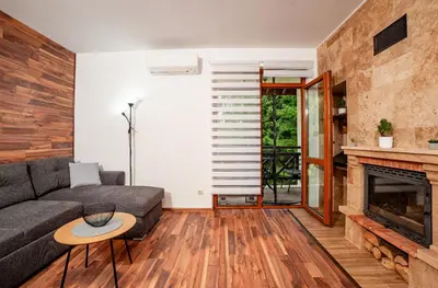 a living room with a couch and a fireplace at Oxygen Time in Smolyan