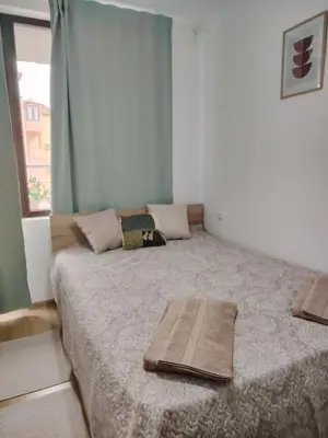 a bedroom with a bed with two pillows on it at Apartament Khan Kubrat in Sandanski