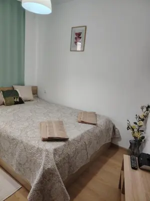 a bedroom with a bed with two towels on it at Apartament Khan Kubrat in Sandanski