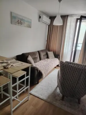 a living room with a couch and a table at Apartament Khan Kubrat in Sandanski