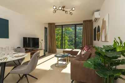 a living room with a couch and a table at Einik Luxury Apartments in Velingrad