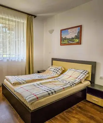 a bedroom with a bed in a room with a window at Everwood Hotel & Restaurant in Govedartsi