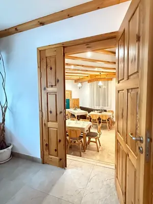 a door leading into a dining room with a table at Everwood Hotel & Restaurant in Govedartsi