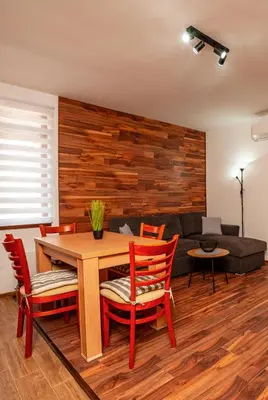 a dining room with a table and chairs and a couch at Oxygen Time in Smolyan
