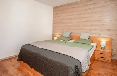 a bedroom with a large bed with two pillows at Oxygen Time in Smolyan