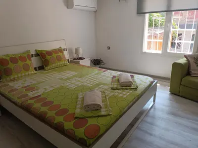 a bedroom with a large bed and a couch at Wendy House - Central Sofia - 3BRDR - Private Courtyard - 5 min to Vitosha blvd in Sofia