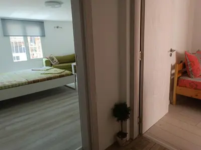 a room with a bedroom with a bed and a doorway at Wendy House - Central Sofia - 3BRDR - Private Courtyard - 5 min to Vitosha blvd in Sofia